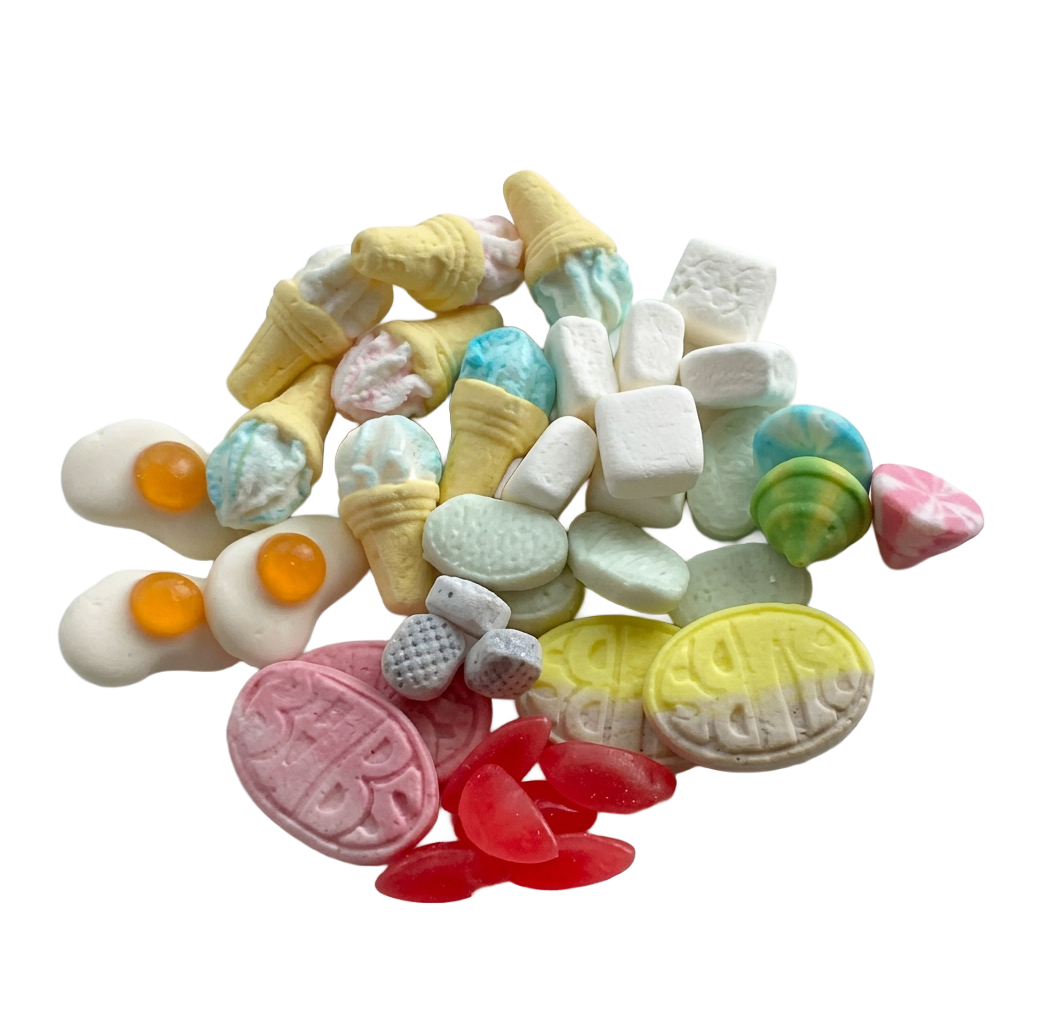A pile of gelatin free Swedish candy assorted miniatures and confection pieces, including ice cream cone shapes, egg-shaped pieces with orange yolks, pastel marshmallows, marbled candies, and yellow and pink embossed pieces, isolated on a white background.