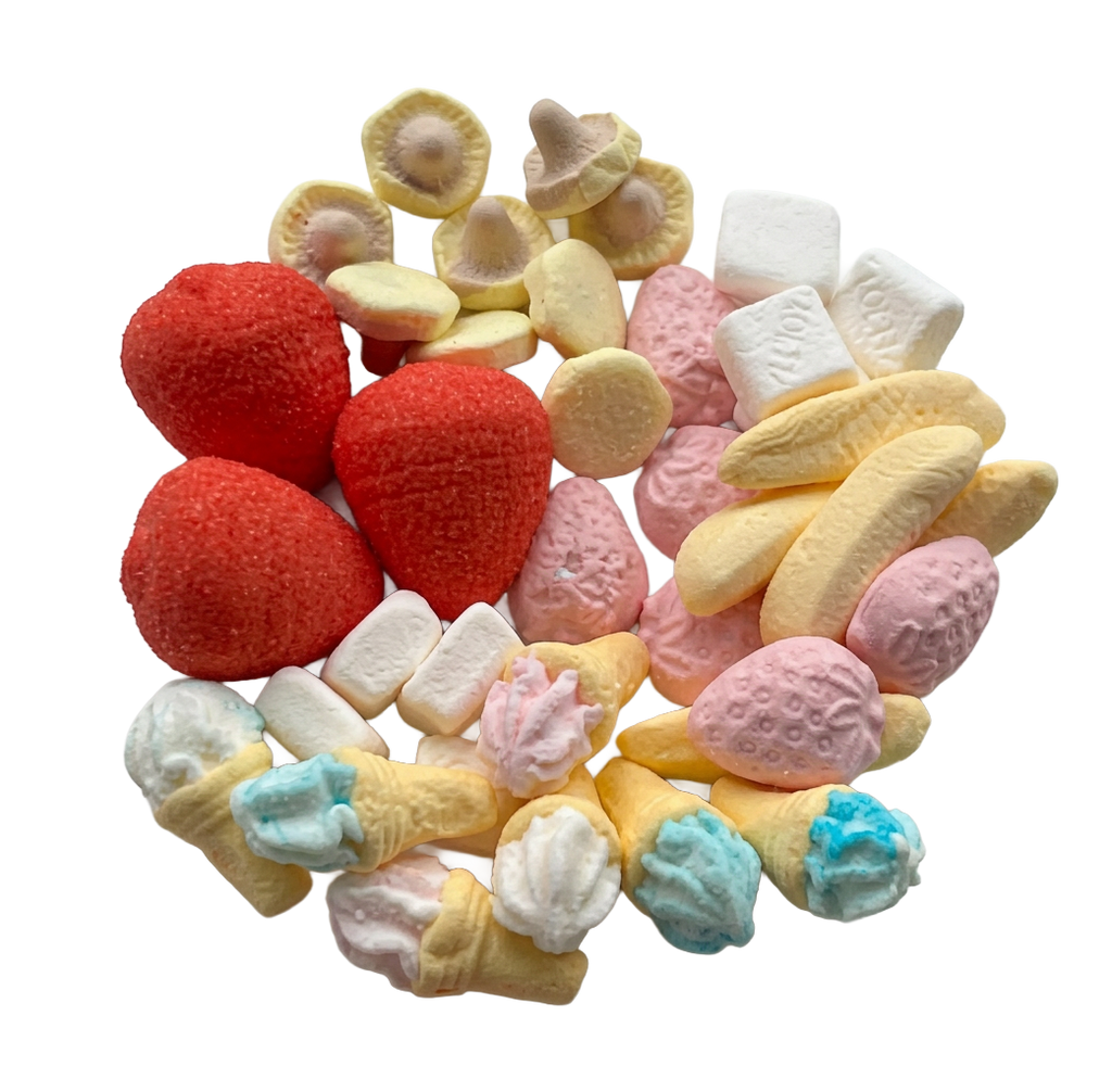 A pile of assorted miniature Swedish candies shaped like strawberries, bananas, ice cream cones, marshmallows, and flower petals in red, pink, yellow, blue, and white, isolated on a white background.