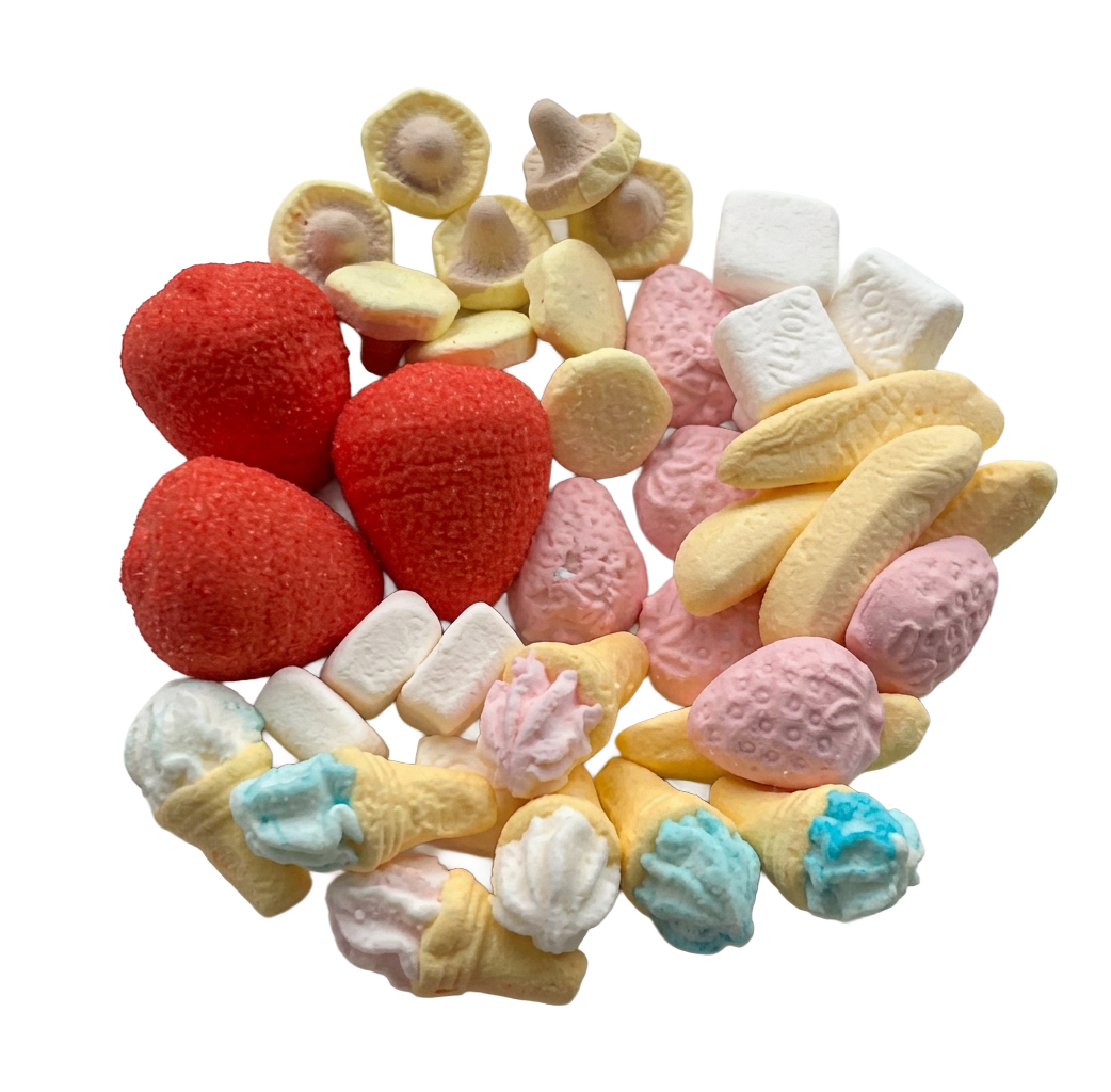 A pile of assorted miniature Swedish candies shaped like strawberries, bananas, ice cream cones, marshmallows, and flower petals in red, pink, yellow, blue, and white, isolated on a white background.